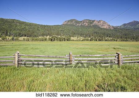 Stock Image - Wooden Fence and Meadow. Fotosearch
