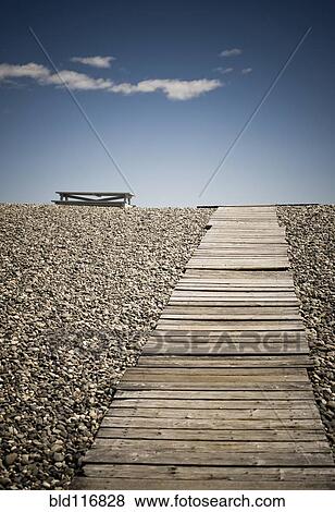 Stock Photo - Wooden Walkway and Picnic Table at the Beach. Fotosearch