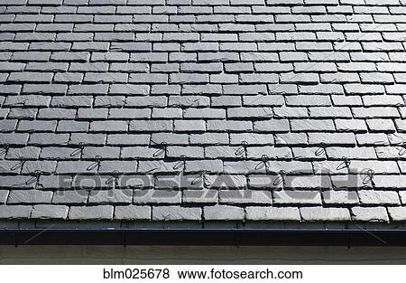 Stock Photo - A black slate roof and gutter. Fotosearch