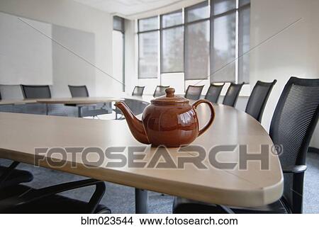 A brown china teapot on boardroom table in empty boardroom View Large Photo Image Picture - A brown china teapot on boardroom table in empty boardroom. Fotosearch