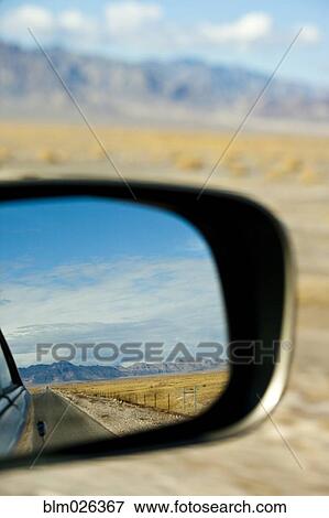 A car driving through the desert landscape View Large Photo Image Stock Photo - A car driving through the desert landscape. Fotosearch