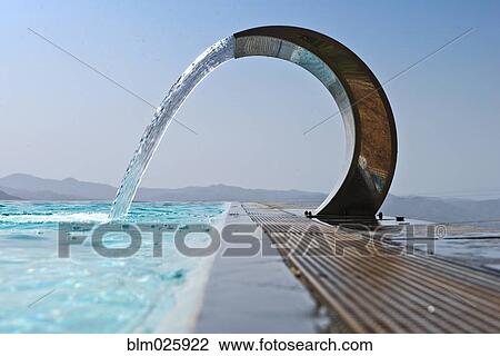 A curved stainless steel water fountain with water flowing View Large Photo Image Stock Image - A curved stainless steel water fountain with water flowing . Fotosearch