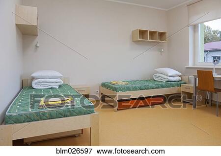 A dormitory bedroom with beds and bed linen View Large Photo Image Stock Photo - A dormitory bedroom with beds and bed linen. Fotosearch