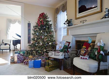 Stock Image - A formal living room with Christmas tree and gifts. Fotosearch