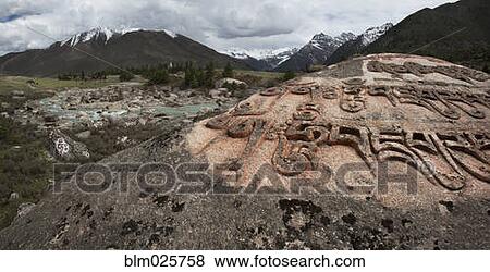Stock Photo - A giant Mani prayer rock. Fotosearch