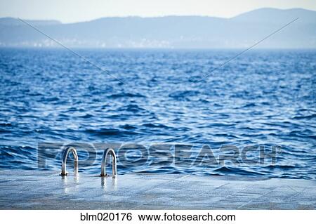 A ladder leading down to the water for swimmers View Large Photo Image Stock Photograph - A ladder leading down to the water for swimmers. Fotosearch