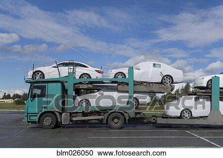 A large bulk transporter loaded with new cars for delivery View Large Photo Image Stock Image - A large bulk transporter loaded with new cars for delivery. Fotosearch