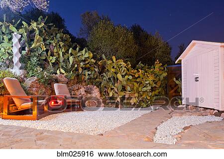 Stock Photograph - A lodge and terrace, surrounded by blooming cactus . Fotosearch