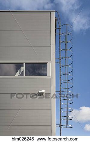 A metal ladder leading up to the roof of an industrial building View Large Photo Image Stock Photography - A metal ladder leading up to the roof of an industrial building. Fotosearch