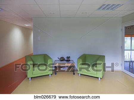 A reception area with two green chairs and a table View Large Photo Image Stock Photo - A reception area with two green chairs and a table. Fotosearch