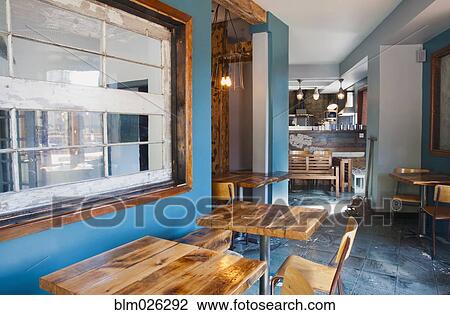 A restaurant with turquoise blue walls and wooden furniture View Large Photo Image Stock Image - A restaurant with turquoise blue walls and wooden furniture. Fotosearch