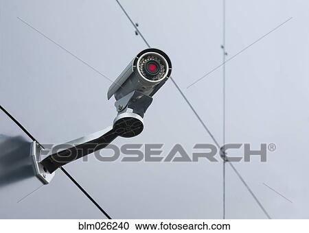 A security camera mounted on the wall of a building View Large Photo Image Stock Image - A security camera mounted on the wall of a building. Fotosearch