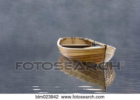 Stock Image - A single wooden rowing boat . Fotosearch