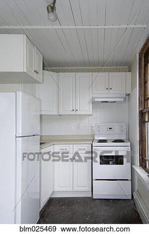 Stock Photo - A small galley kitchen in an old apartment. Fotosearch