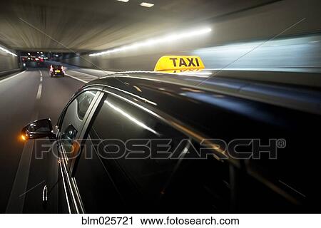 A taxi cab changing lanes in a tunnel View Large Photo Image Stock Image - A taxi cab changing lanes in a tunnel. Fotosearch