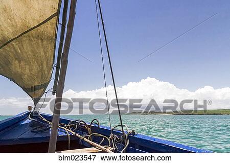 A traditional fishing boat in the emerald sea of Antsiranana View Large Photo Image Stock Photo - A traditional fishing boat in the emerald sea of Antsiranana. Fotosearch