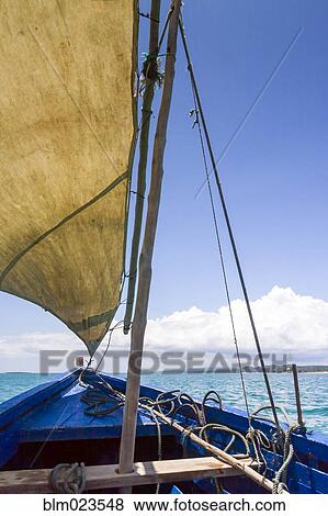 A traditional fishing boat in the emerald sea of Antsiranana View Large Photo Image Stock Photo - A traditional fishing boat in the emerald sea of Antsiranana . Fotosearch