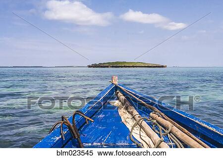 A traditional fishing boat in the emerald sea of Antsiranana View Large Photo Image Stock Photography - A traditional fishing boat in the emerald sea of Antsiranana. Fotosearch