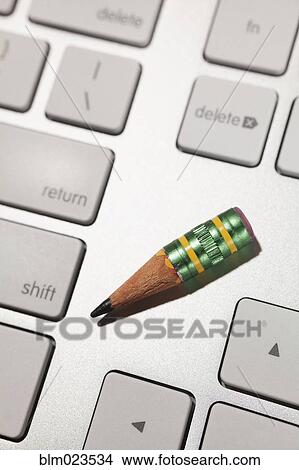 A very small sharpened lead pencil on a computer keyboard View Large Photo Image Picture - A very small sharpened lead pencil on a computer keyboard. Fotosearch