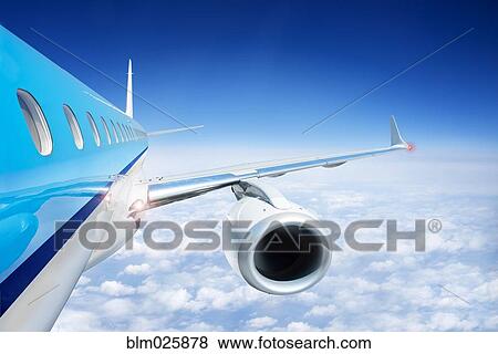 Airliner in flight above the clouds View Large Photo Image Stock Photo - Airliner in flight above the clouds. Fotosearch