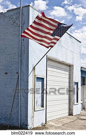 Stock Photo - American Flag on an Abandoned Building. Fotosearch