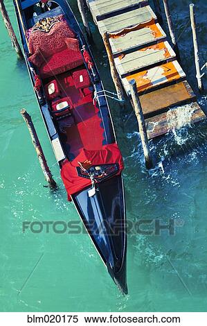 An empty gondola docked at a worn out pier in the city of Venice, Italy View Large Photo Image Stock Photography - An empty gondola docked at a worn out pier in the city of Venice, Italy. Fotosearch