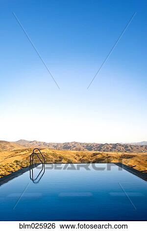 Stock Photograph - An infinity water pool with steps . Fotosearch