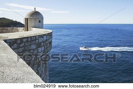 Stock Photo - An outpost overlooking the Adriatic Sea on the old city wall in Dubrovnik. Fotosearch