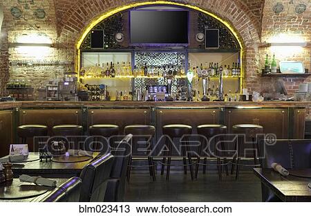 Bar full of drinks with big TV screen on wall View Large Photo Image Stock Image - Bar full of drinks with big TV screen on wall. Fotosearch