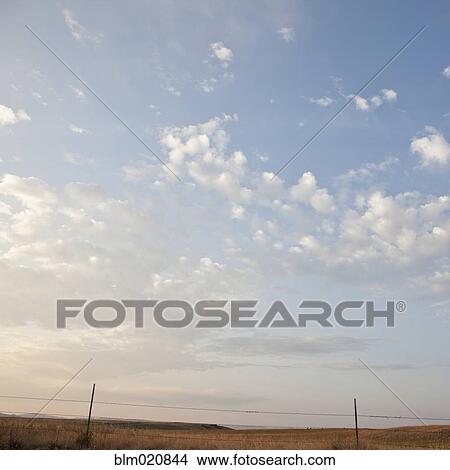 Barbed Wire Fence with Grassland Landscape View Large Photo Image Picture - Barbed Wire Fence with Grassland Landscape. Fotosearch