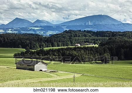 Stock Photo - Barn in Field with Mountain Background. Fotosearch