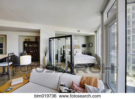 Bedroom Area and Living Room in Upscale Studio Apartment View Large Photo Image Stock Photograph - Bedroom Area and Living Room in Upscale Studio Apartment. Fotosearch