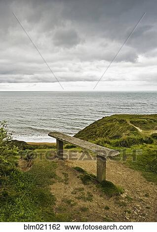 Stock Image - Bench Overlooking Ocean. Fotosearch