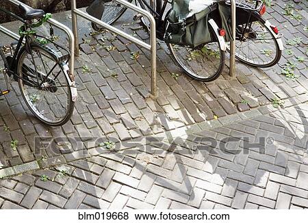 Bikes Parked at Racks View Large Photo Image Stock Photo - Bikes Parked at Racks. Fotosearch