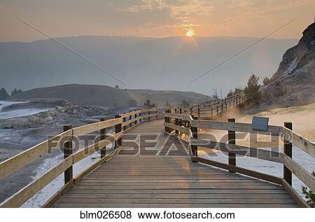Stock Photo - Boardwalk over the waters and landscape of the hot springs. Fotosearch