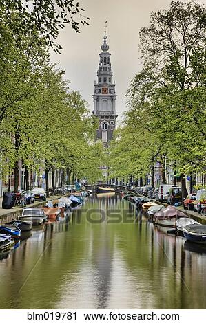 Stock Image - Boats and Tree Lined Canal. Fotosearch