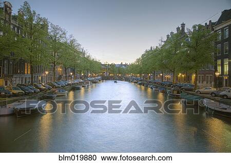 Boats in a Tree Lined Canal at Dusk View Large Photo Image Stock Image - Boats in a Tree Lined Canal at Dusk. Fotosearch