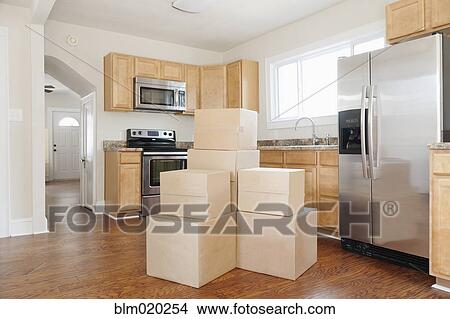 Picture - Boxes and cartons stacked in a house. Fotosearch