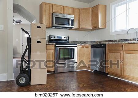 Stock Photo - Boxes and cartons stacked in a house. Fotosearch