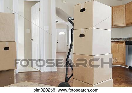 Boxes and cartons stacked in a house View Large Photo Image Stock Photo - Boxes and cartons stacked in a house. Fotosearch