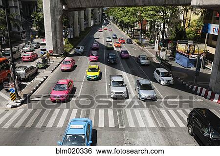 Bright colored taxis mix with other cars in Bangkok traffic View Large Photo Image Stock Photograph - Bright colored taxis mix with other cars in Bangkok traffic. Fotosearch