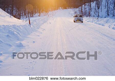 Stock Photograph - Car on Snow Covered Road. Fotosearch