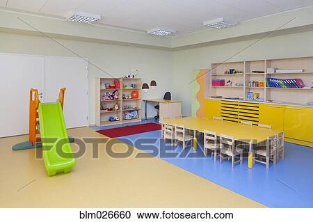 Stock Image - Classroom, activity room with furniture, tables and chairs. Fotosearch