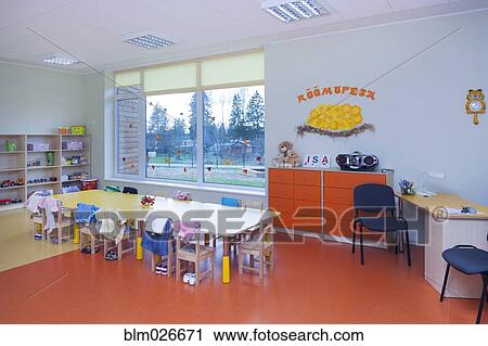 Stock Image - Classroom, activity room with furniture, tables and chairs. Fotosearch