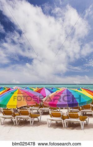 Colorful umbrellas on the beach on Isla Mujeres, Yucatan Peninsula View Large Photo Image Stock Photo - Colorful umbrellas on the beach on Isla Mujeres, Yucatan Peninsula. Fotosearch