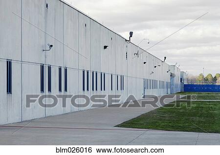 Concrete Building, Prison Yard, and surveillance cameras at a Correctional Facility View Large Photo Image Stock Photograph - Concrete Building, Prison Yard, and surveillance cameras at a Correctional Facility. Fotosearch