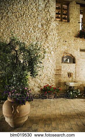Stock Image - Courtyard and Stone House Exterior. Fotosearch