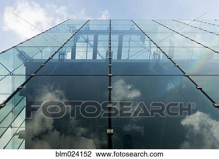 Stock Image - Diffraction of light on the glass facade of an office building. Fotosearch