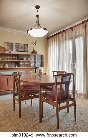 Dining room table and chairs in a home View Large Photo Image Stock Photography - Dining room table and chairs in a home. Fotosearch