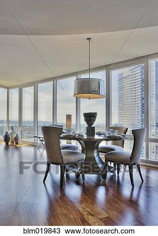 Stock Image - Dining Table and Chairs with City View. Fotosearch